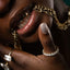 Model's bottom half of face, showing gold front teeth, 14k gold paperclip necklace and 14k gold cuban necklace