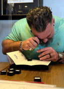 Man signing a document with a pen at a desk