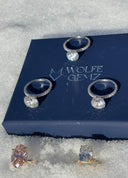 Jewelry set on a Wolfe Gemz branded stand with snow in the background