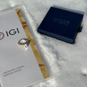 Diamond ring with IGI certification and Wolfe Geniz box on a textured surface